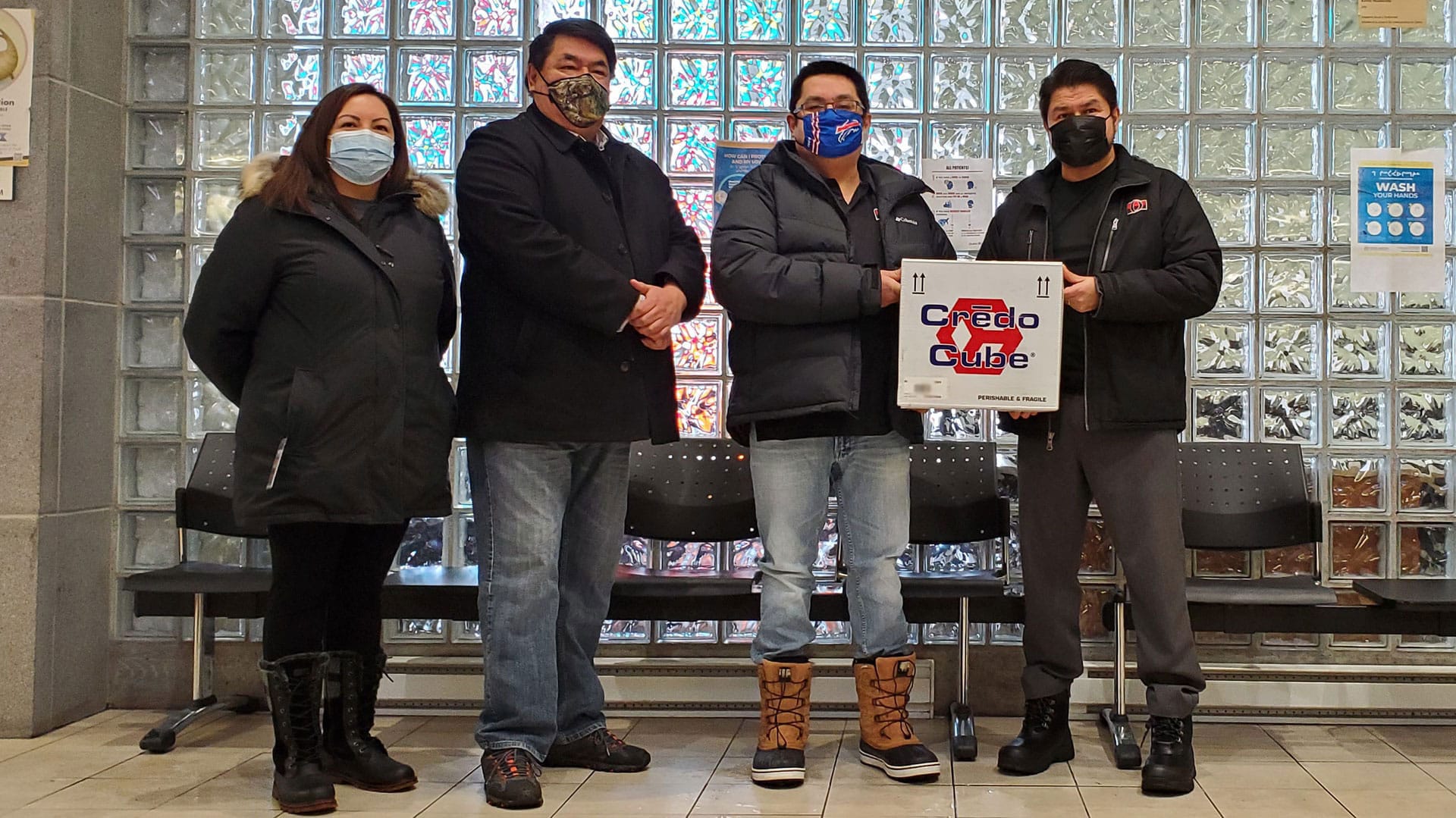 Waswanipi CMC and community leaders pose with box of Moderna vaccines