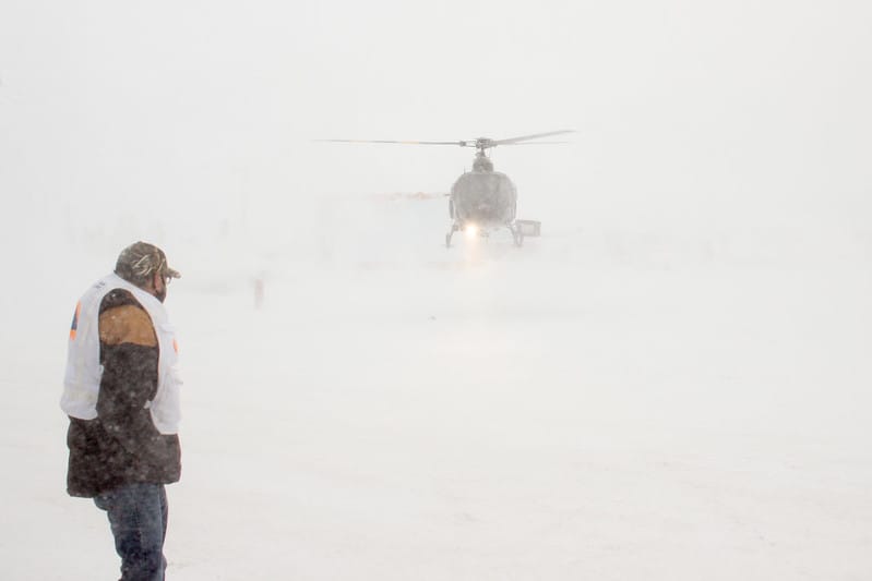 Jason Coonishish watches helicopter land