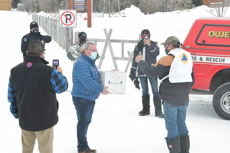 Jason Coonishish gives thumbs-up to man holding box