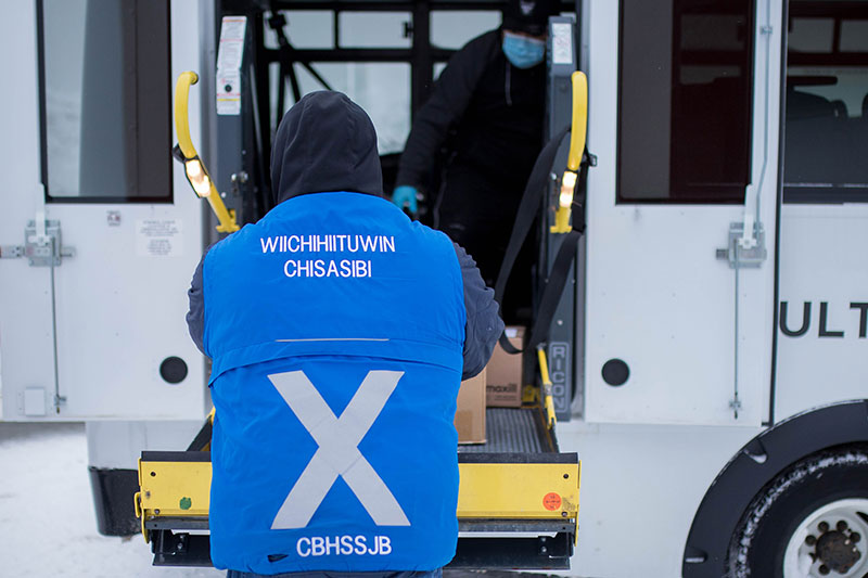 Wiichihiituwin driver loads box onto MSDC bus
