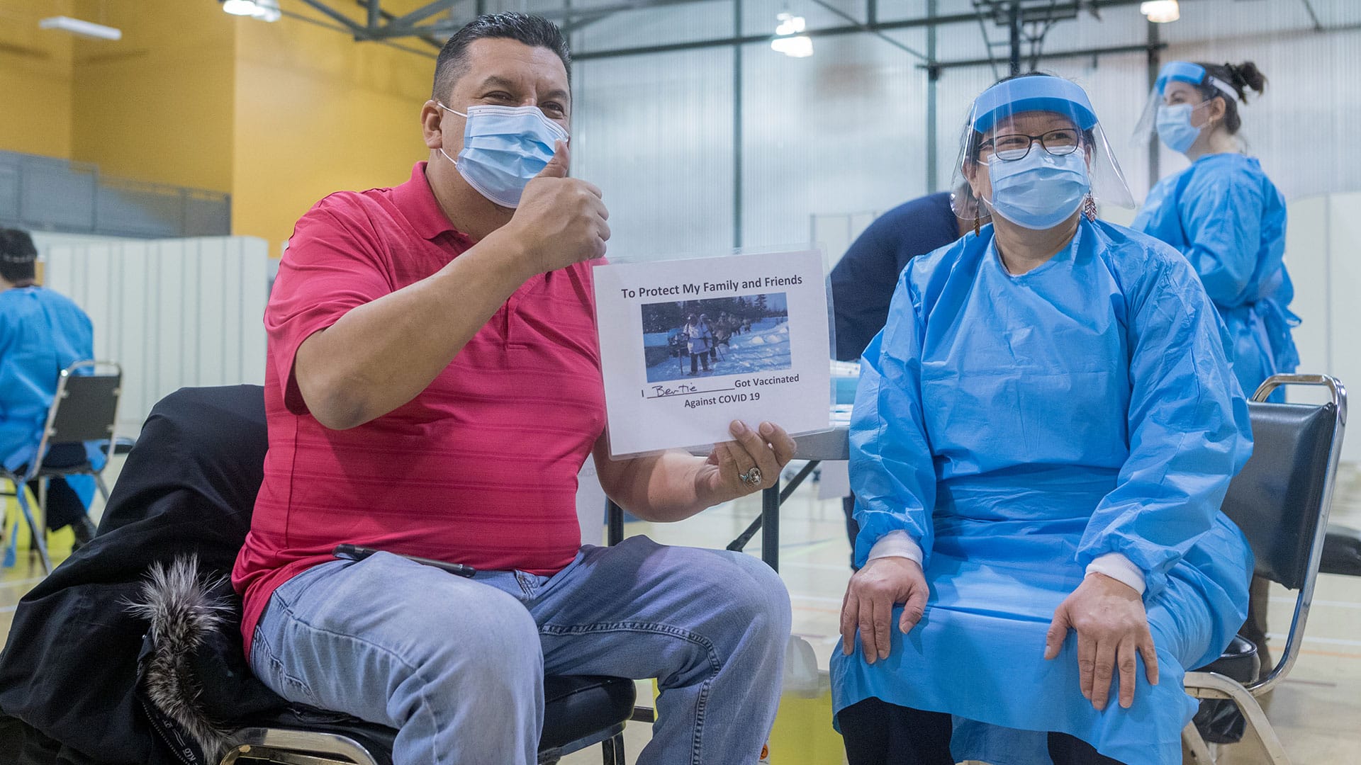 Chair Bertie Wapachee gives thumbs up while getting the vaccine