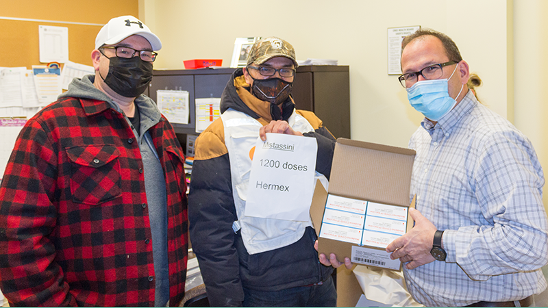 Richard Shecapio and Jason Coonishish deliver vaccines to Martin Nyles, Head of Current Services, Mistissini CMC.