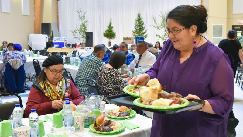 Woman sharing food at community feast