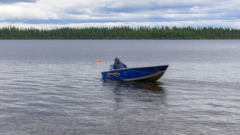 Fisherman in boat on lake