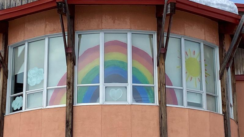 Rainbow mural in window of home