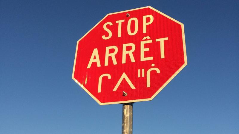 Stop sign in English, French and Cree