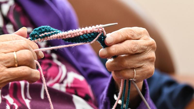 Closeup of elderly woman knitting