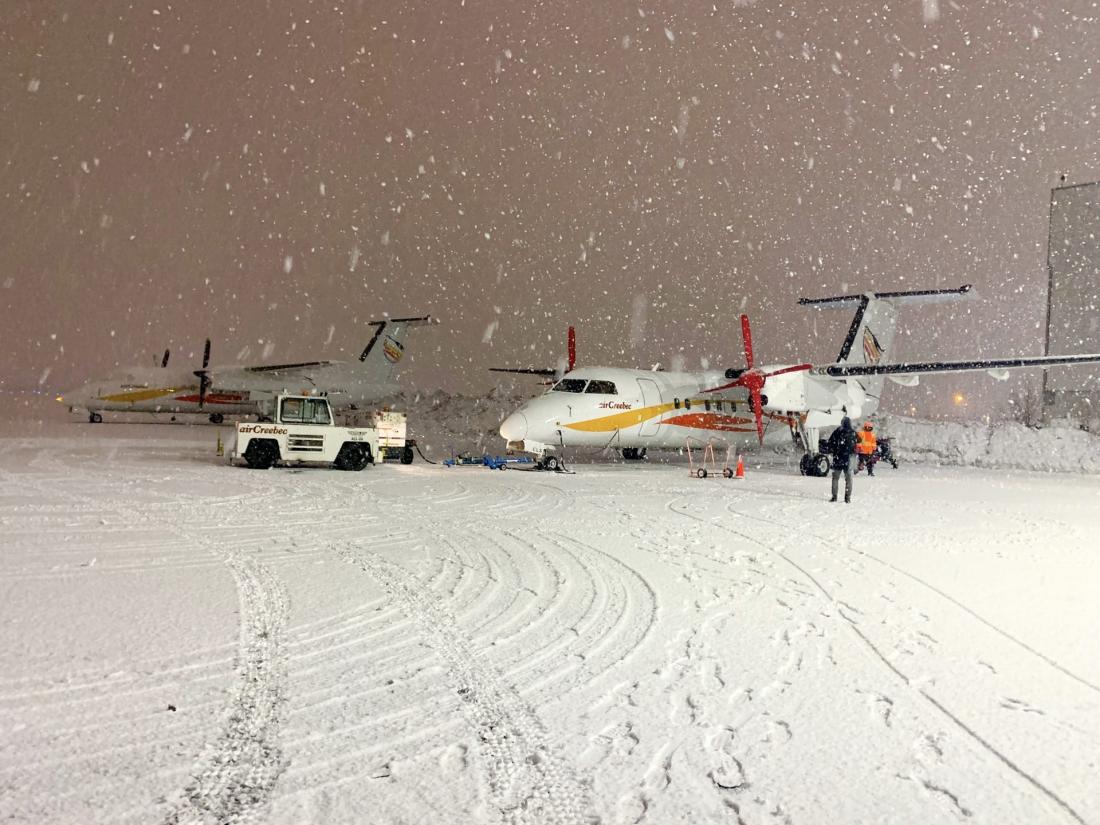 Air Creebec plane on tarmac covered with snow
