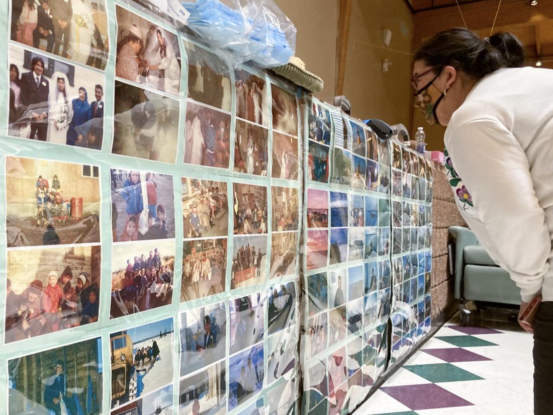 Charlotte Kanatewat Moar looks at family photographs posted on Youth Centre wall