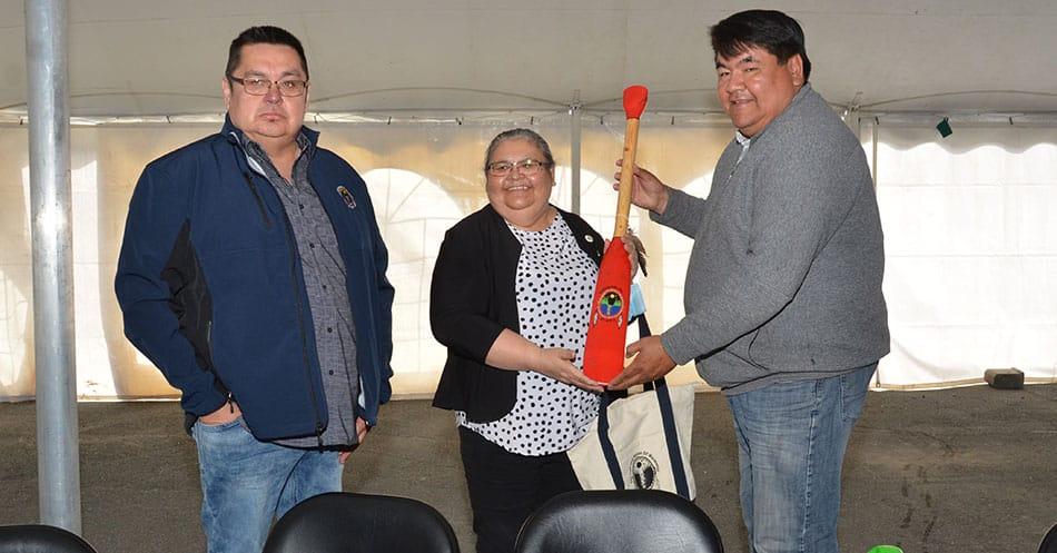 Inland Pole Director Virginia Wabano receives gift of a paddle from Waswanipi Chief and Deputy Chief