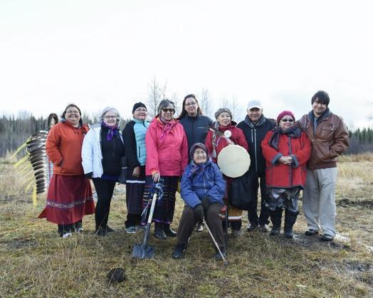 Group of people standing at site of future Robin's Nest Women's Shelter in Waswanipi