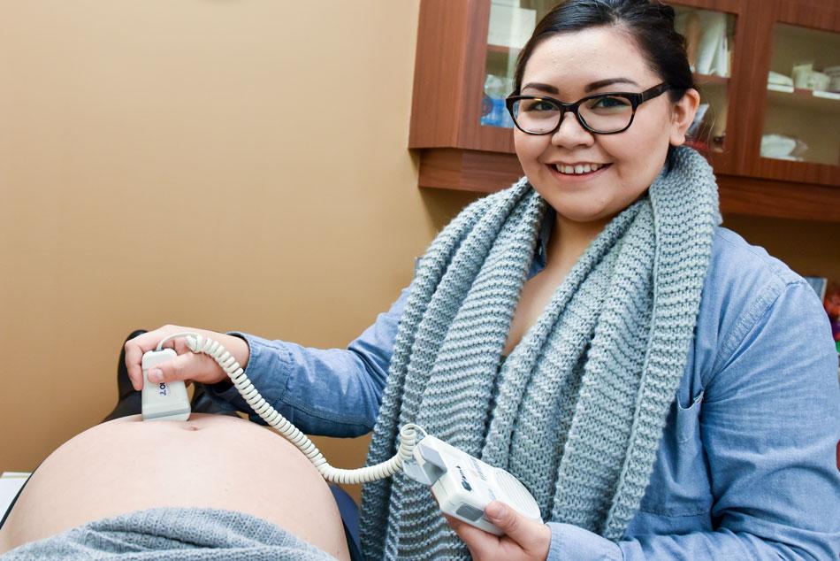 Nurse gives a pregnant woman an ultrasound