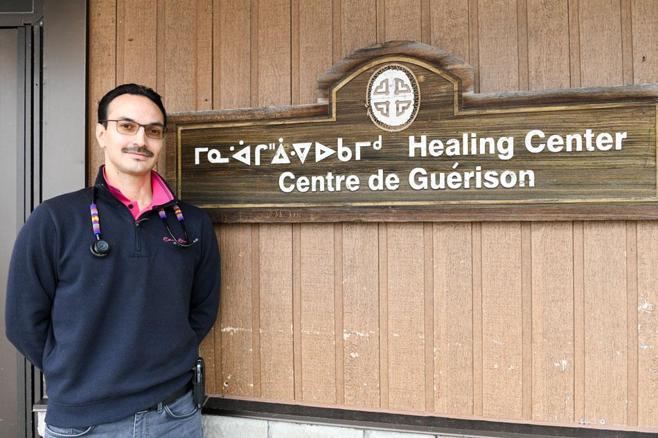 Dr. Brousseau standing in entrance to Oujé-Bougoumou Healing Centre