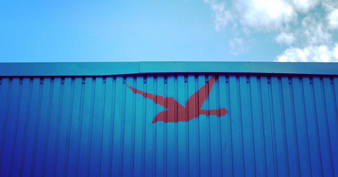 Mural of a red goose on side of blue shipping container