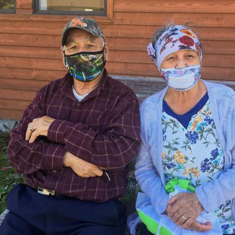 2 elders sitting, wearing masks
