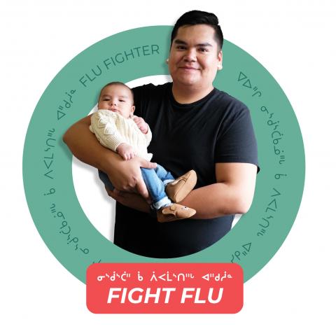 Man holding baby with Fight Flu campaign slogan