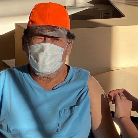 Bertie Wapachee's father receives the vaccine in Nemaska