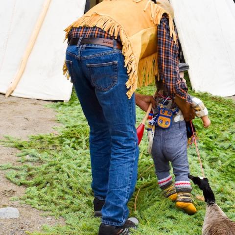 Elder walking with child at walking out ceremony