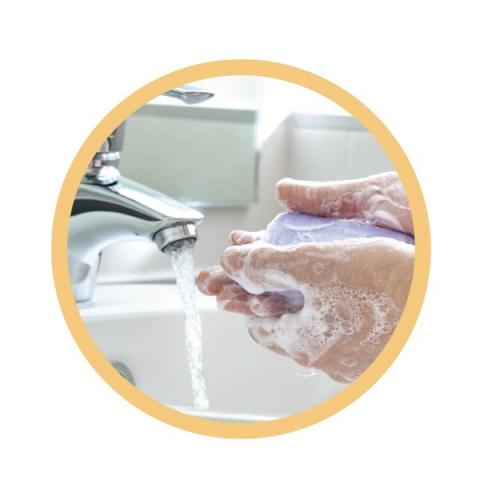 Soapy hands under tap