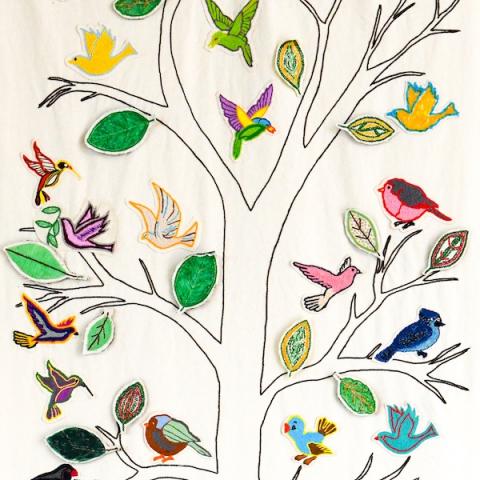 Embroidery of birds and tree on canvas