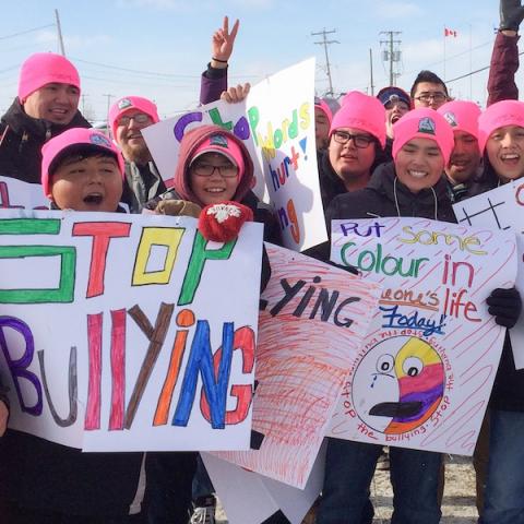 Youth holding signs that say 'stop bullying'