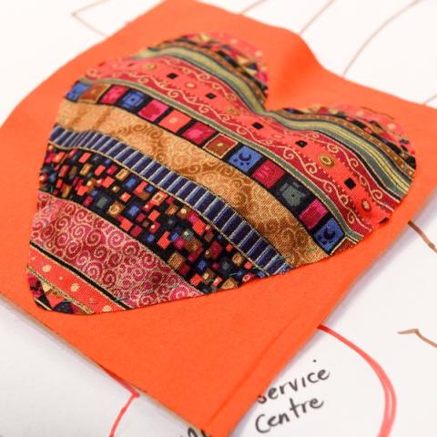 Fabric heart on orange cloth