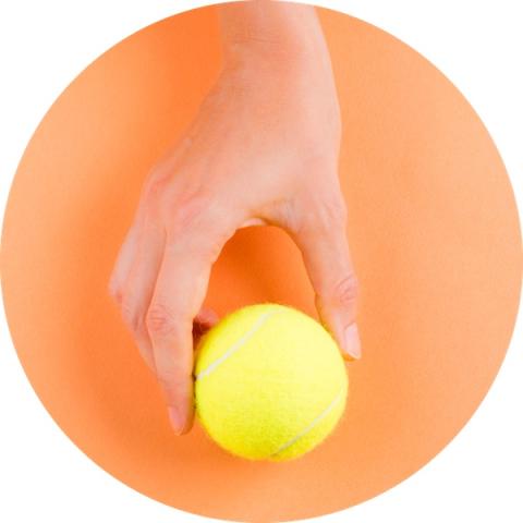 Hand holding tennis ball